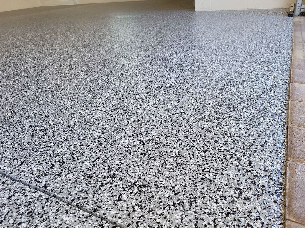 Granite-like epoxy-coated floor, with grey, black, and white speckled pattern.