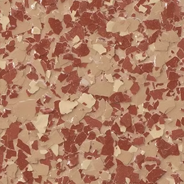 Close-up of a speckled floor coating, featuring red, tan, and cream-colored flakes.