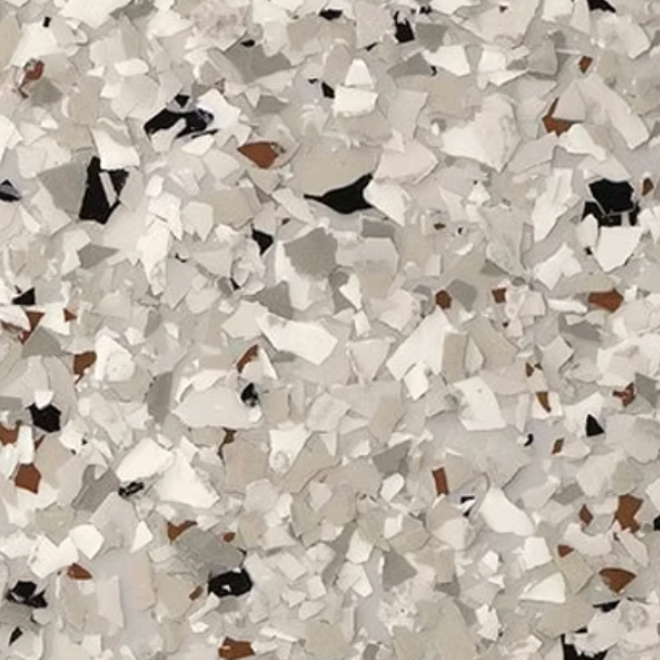 Close-up of a speckled floor coating, primarily white and gray, with flecks of brown and black.
