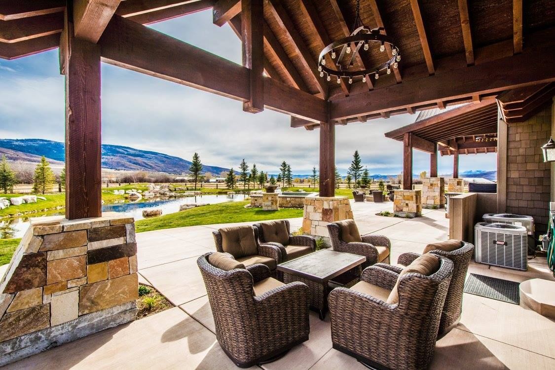 There are a lot of chairs and a table on the patio.