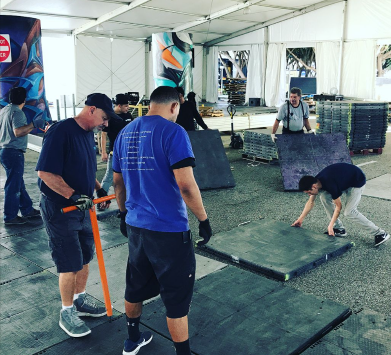 Picture of workers removing event flooring material.