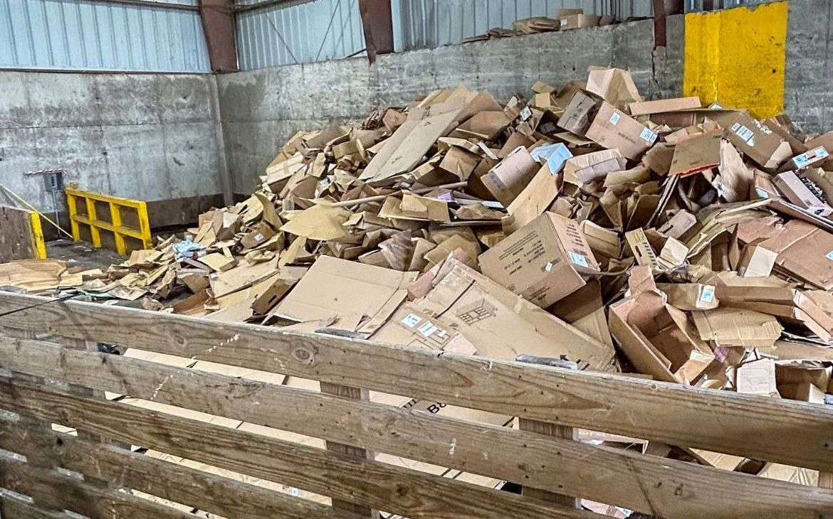 A bunch of cardboard boxes are stacked on top of each other.