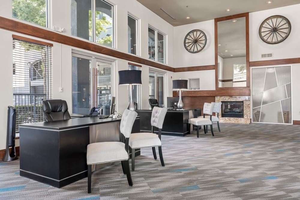 Apartment leasing office with a desk and chairs at Marquis at Texas Street in Dallas, TX.