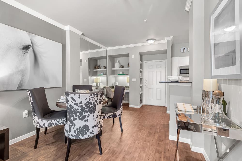 Apartment dining room with a table and chairs at Marquis at Texas Street in Dallas, TX.