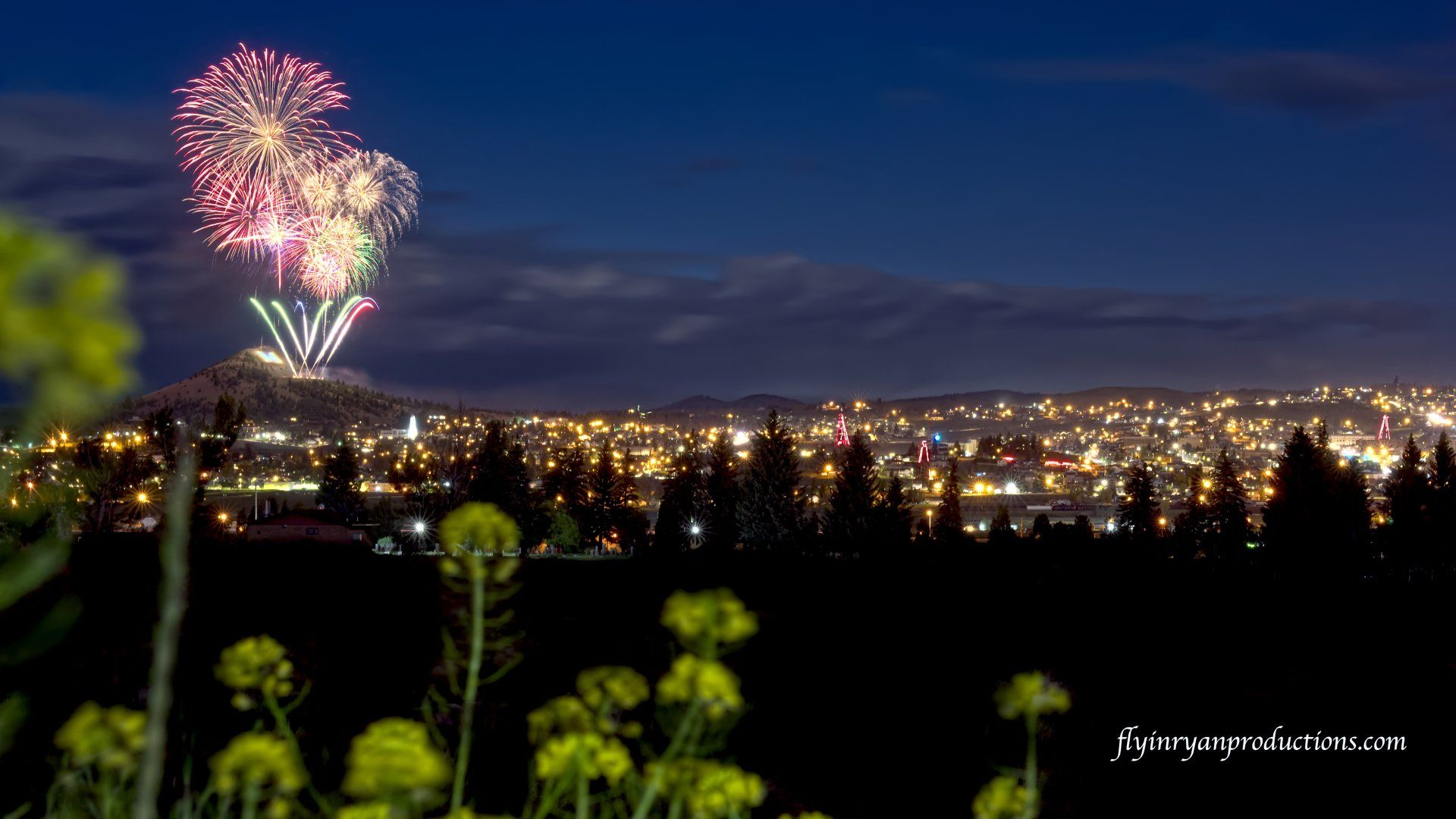 Fireworks exploding in the night sky over  Butte, MT