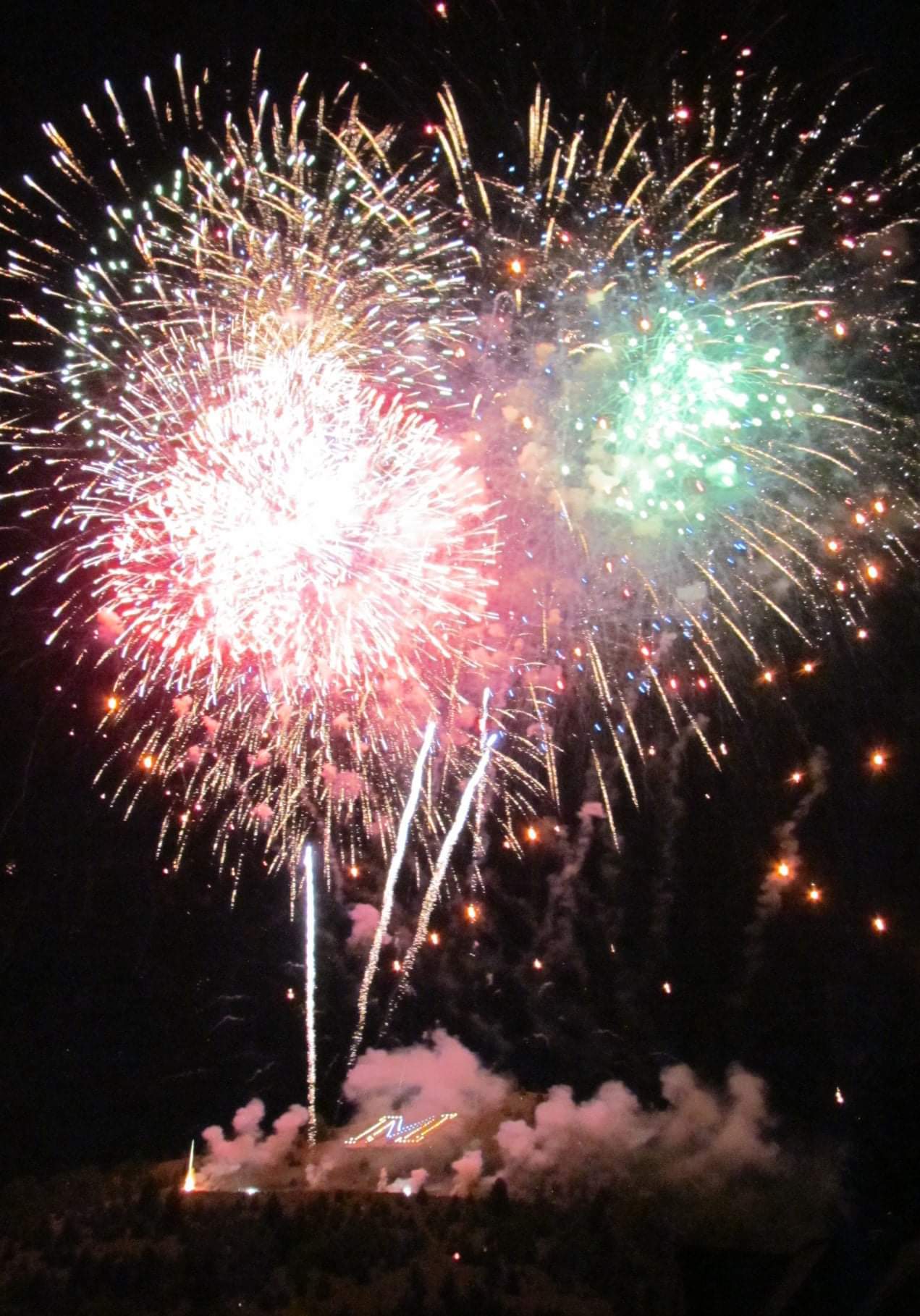 Fireworks exploding in the night sky over  Butte, MT