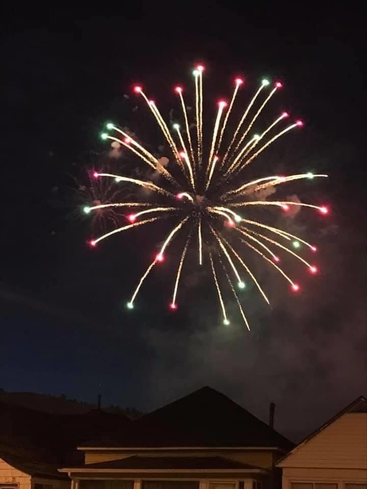 Fireworks exploding in the night sky over  Butte, MT