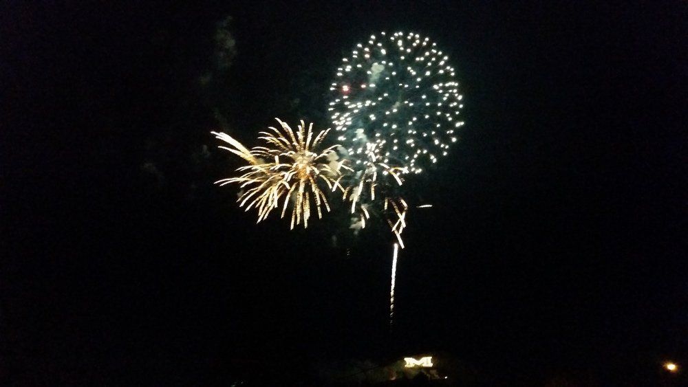 Steve Abraham Fireworks exploding in the night sky over  Butte, MT