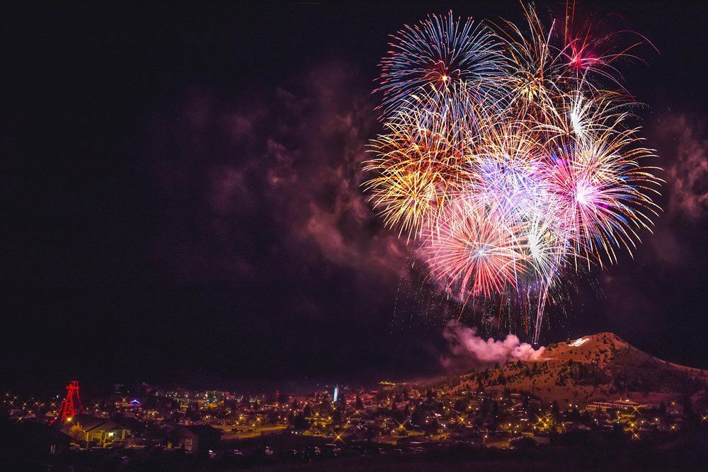 Angela Vidrich Fireworks exploding in the night sky over  Butte, MT