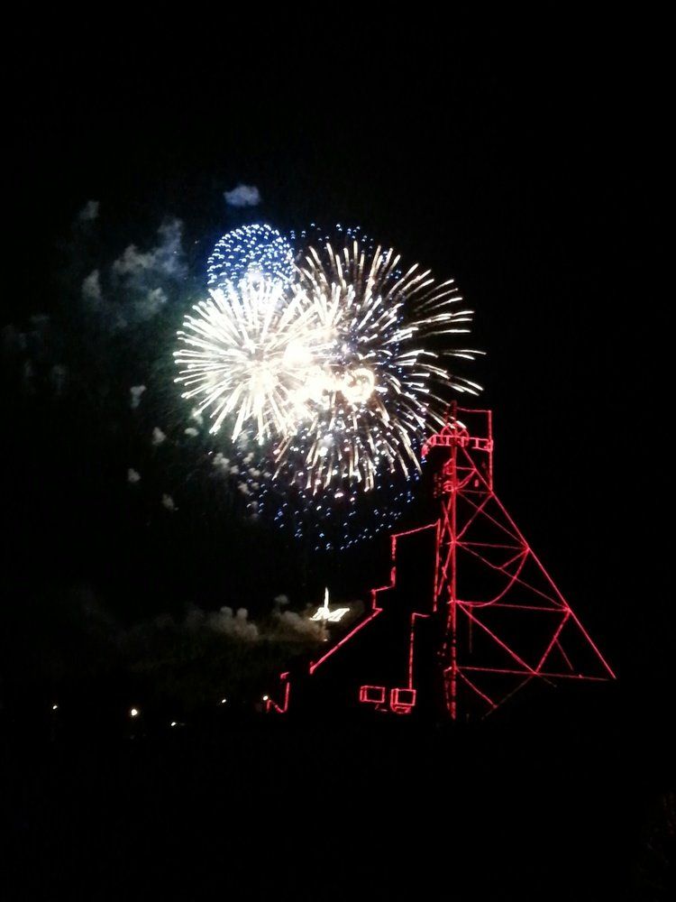 Lyndsay Alt Fireworks exploding in the night sky over  Butte, MT