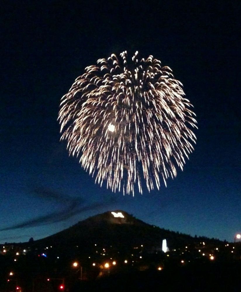 L Gibson Fireworks exploding in the night sky over  Butte, MT