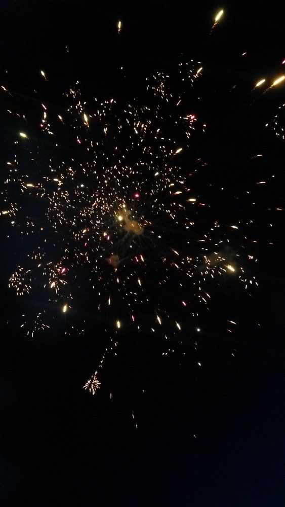 Crystal Corson Fireworks exploding in the night sky over  Butte, MT