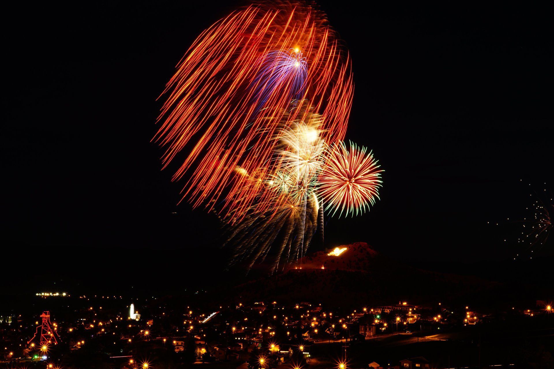 Bart Bratlien Fireworks exploding in the night sky over  Butte, MT