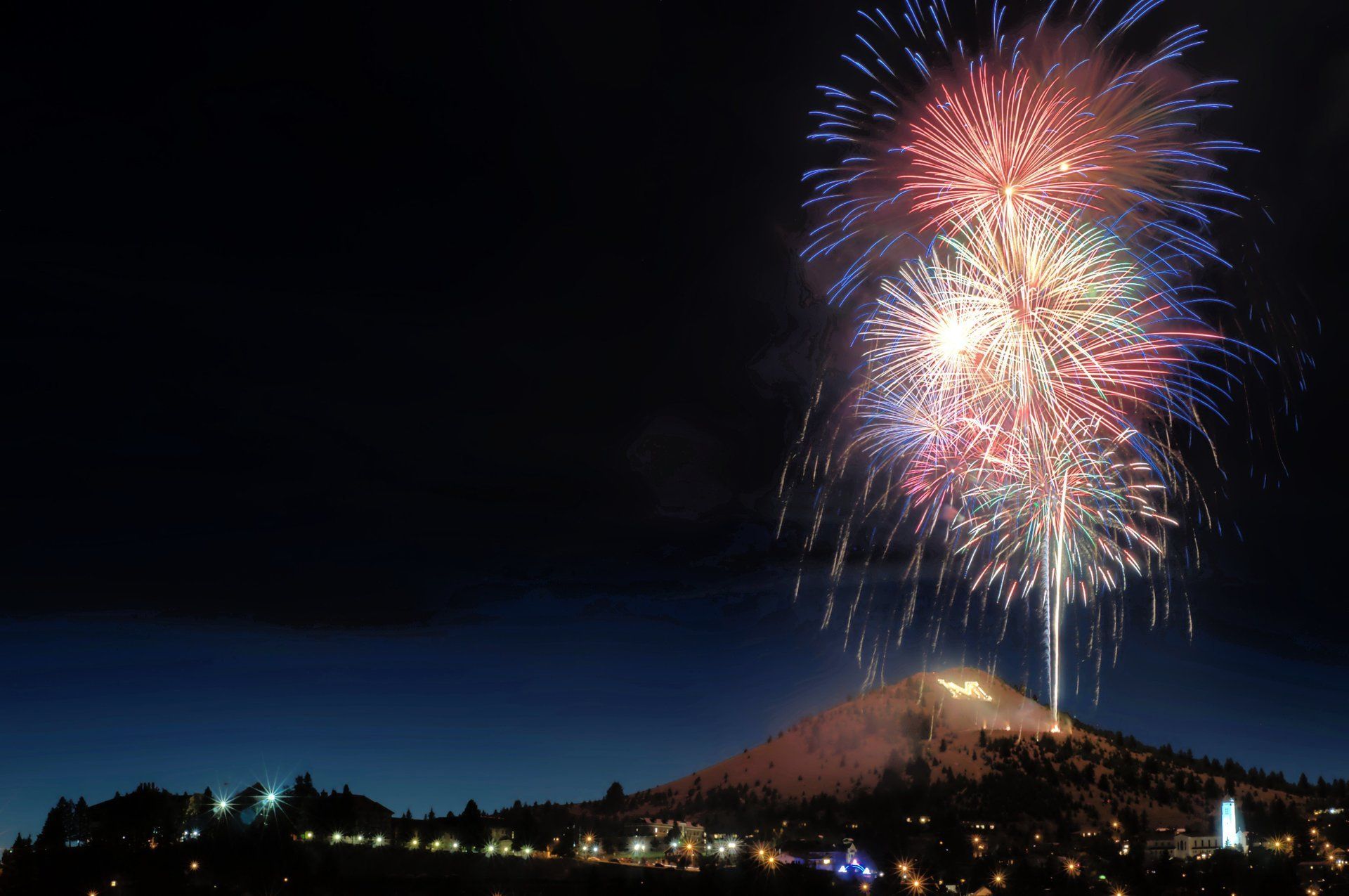 Matt Garcia Fireworks exploding in the night sky over  Butte, MT