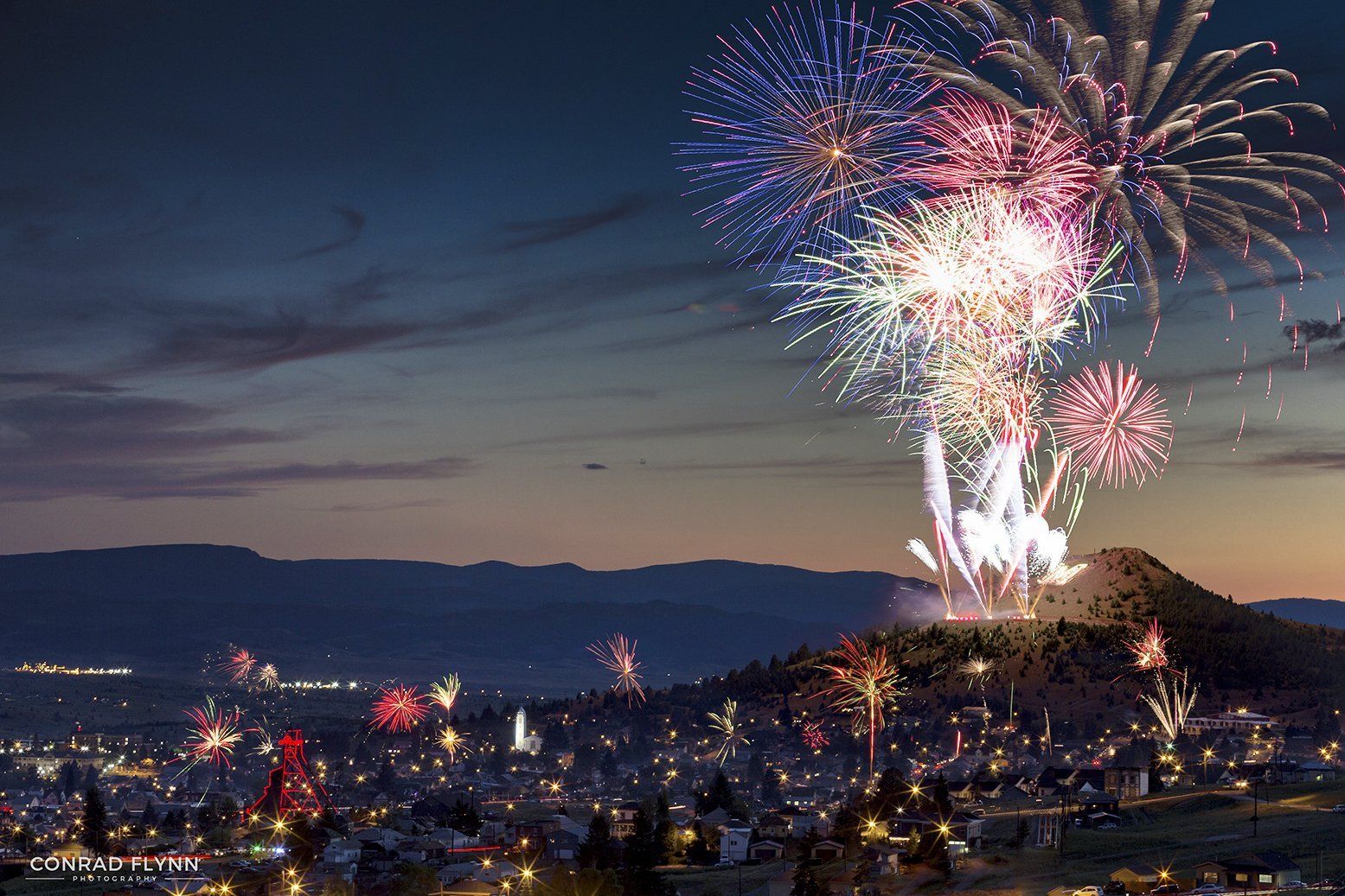 Conrad Flynn Fireworks exploding in the night sky over  Butte, MT