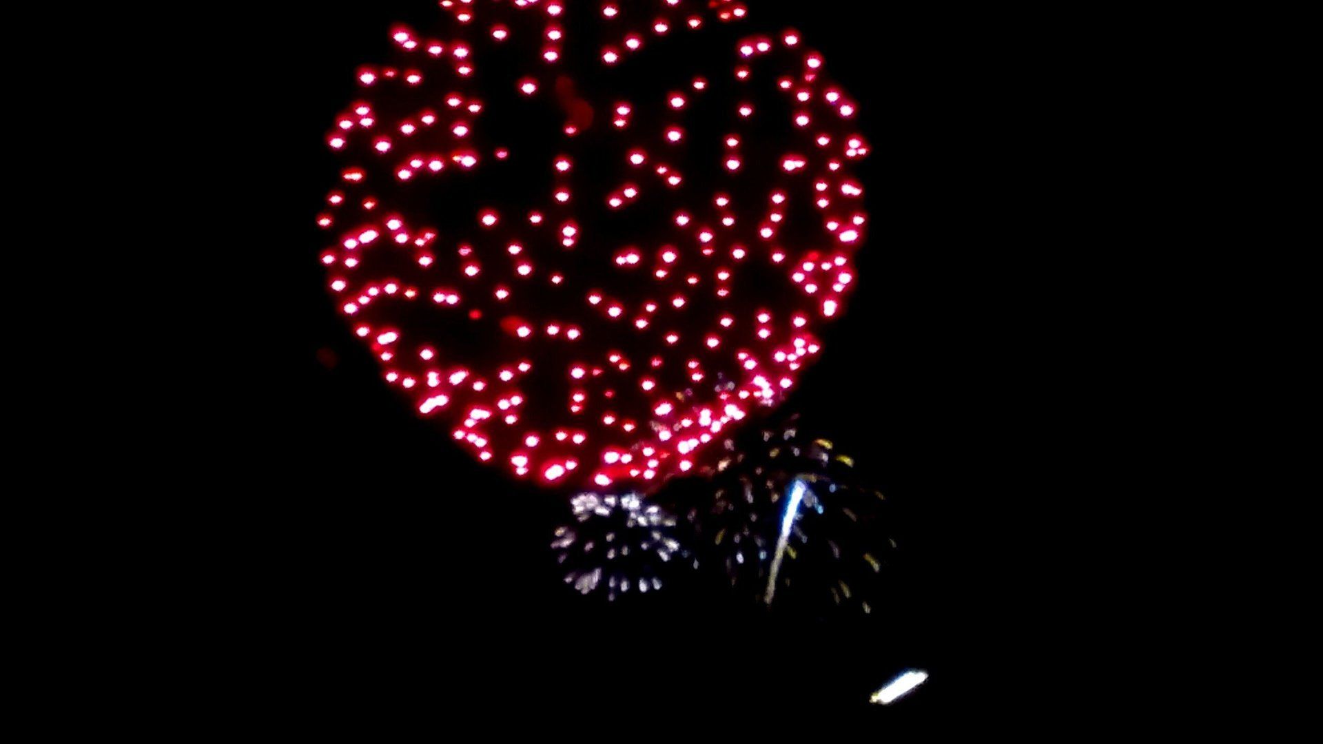 Jennifer Tregear Fireworks exploding in the night sky over  Butte, MT