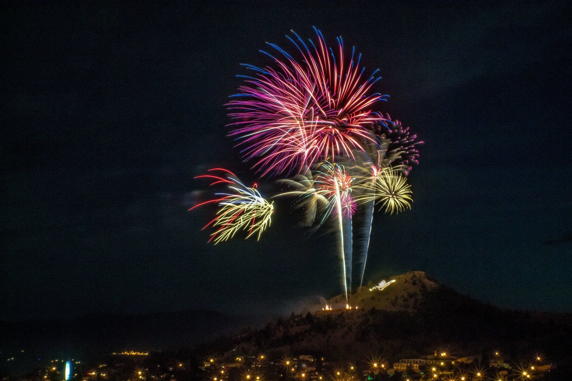 Breanna Summers Fireworks exploding in the night sky over  Butte, MT
