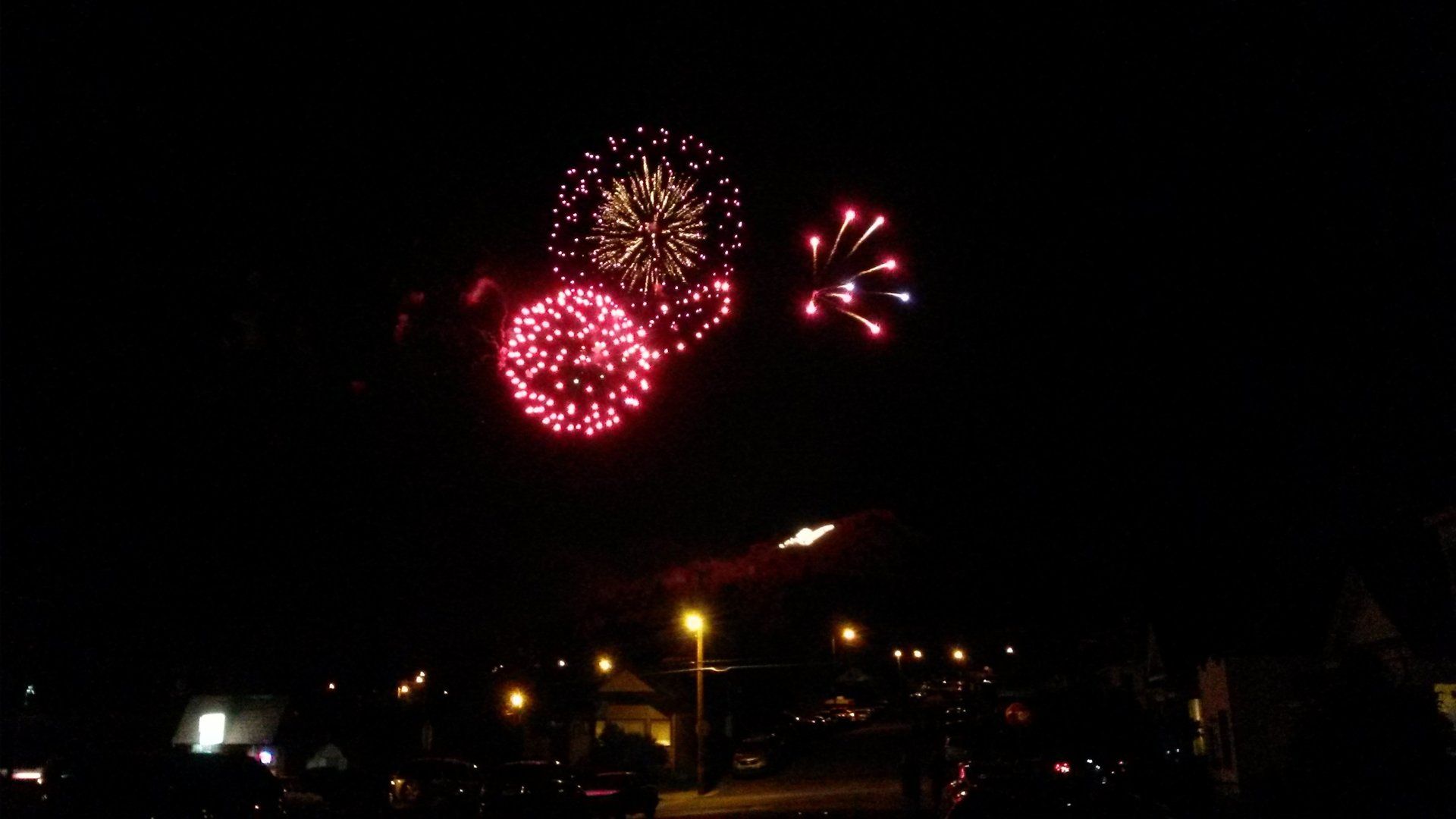 Whittni Cabrera Fireworks exploding in the night sky over  Butte, MT