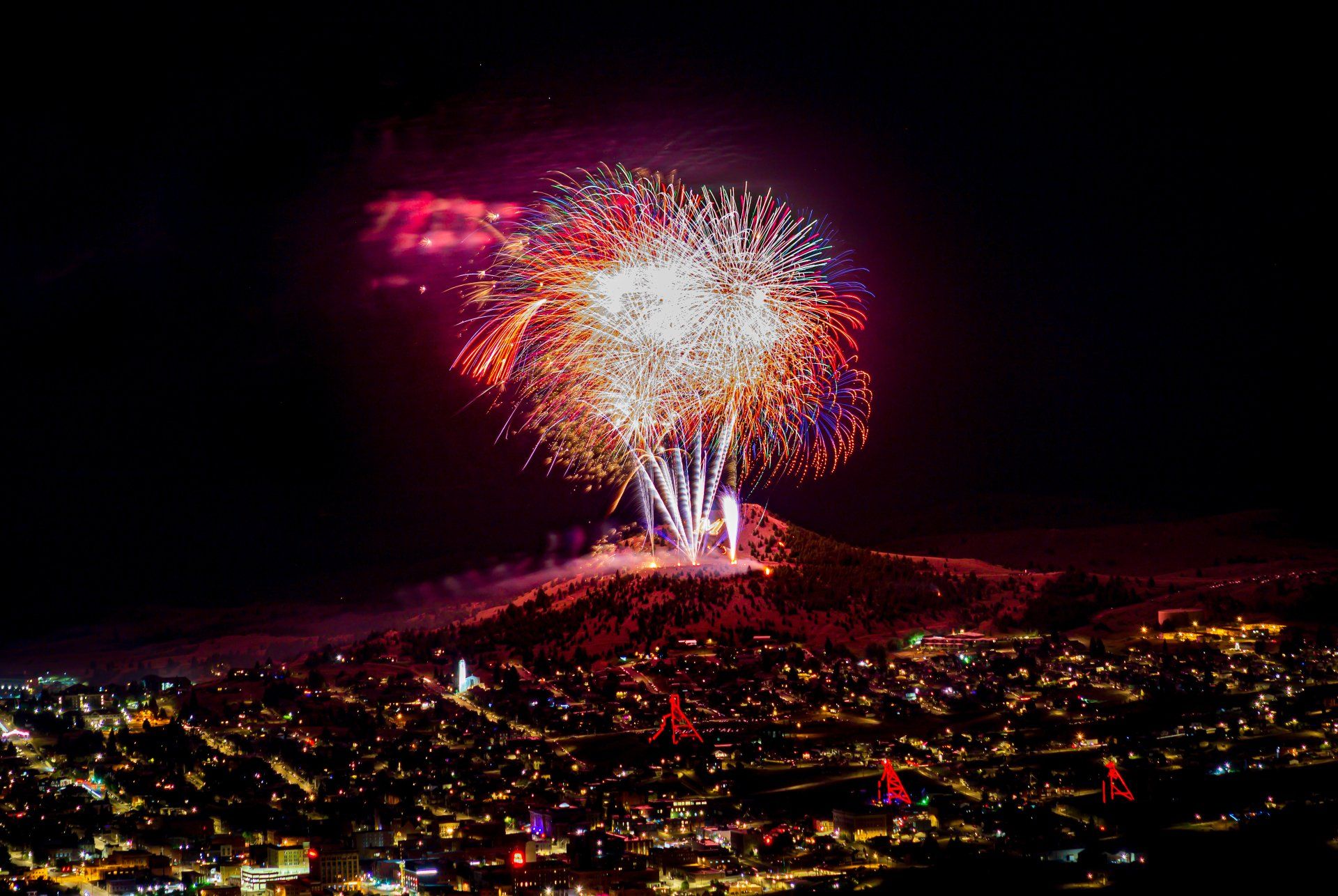 Fireworks exploding in the night sky over  Butte, MT