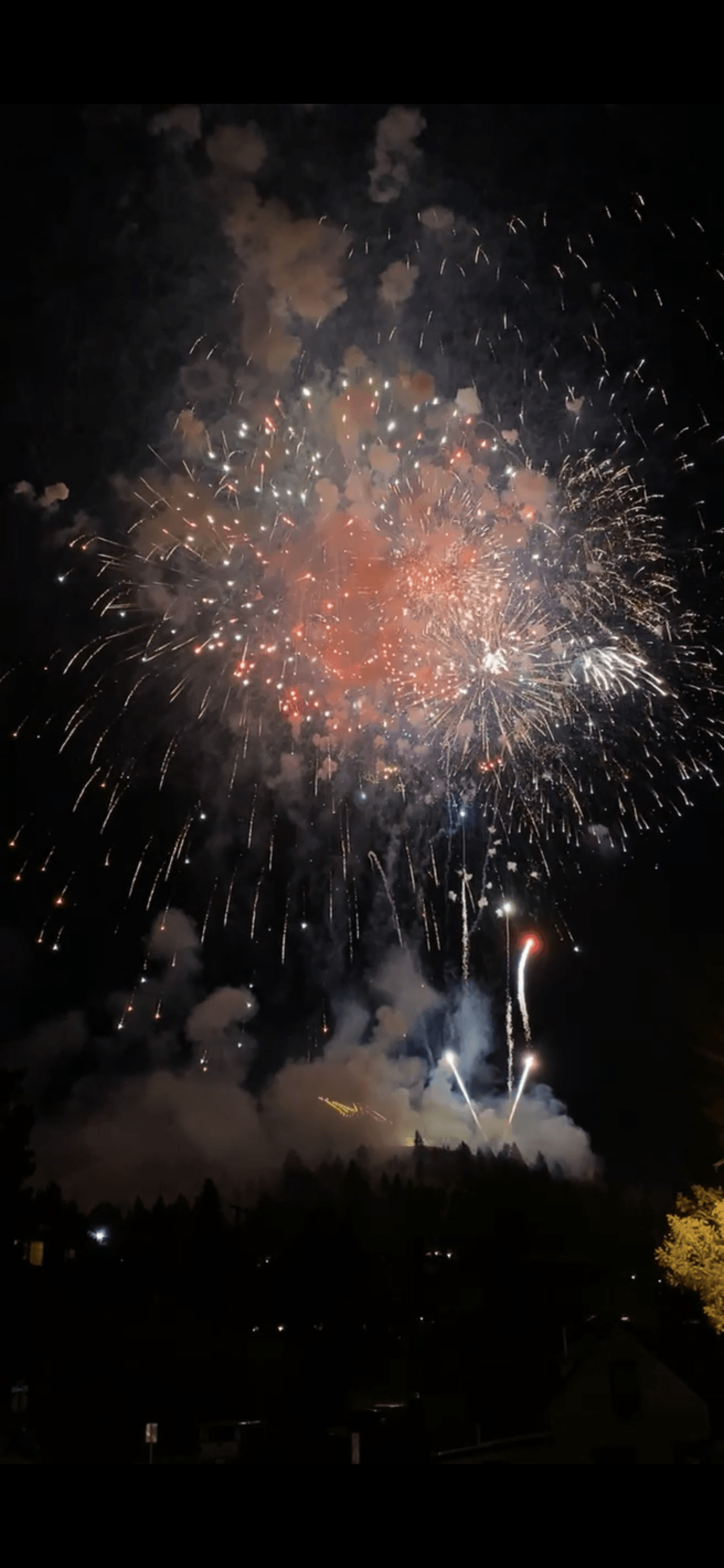 Fireworks exploding in the night sky over  Butte, MT