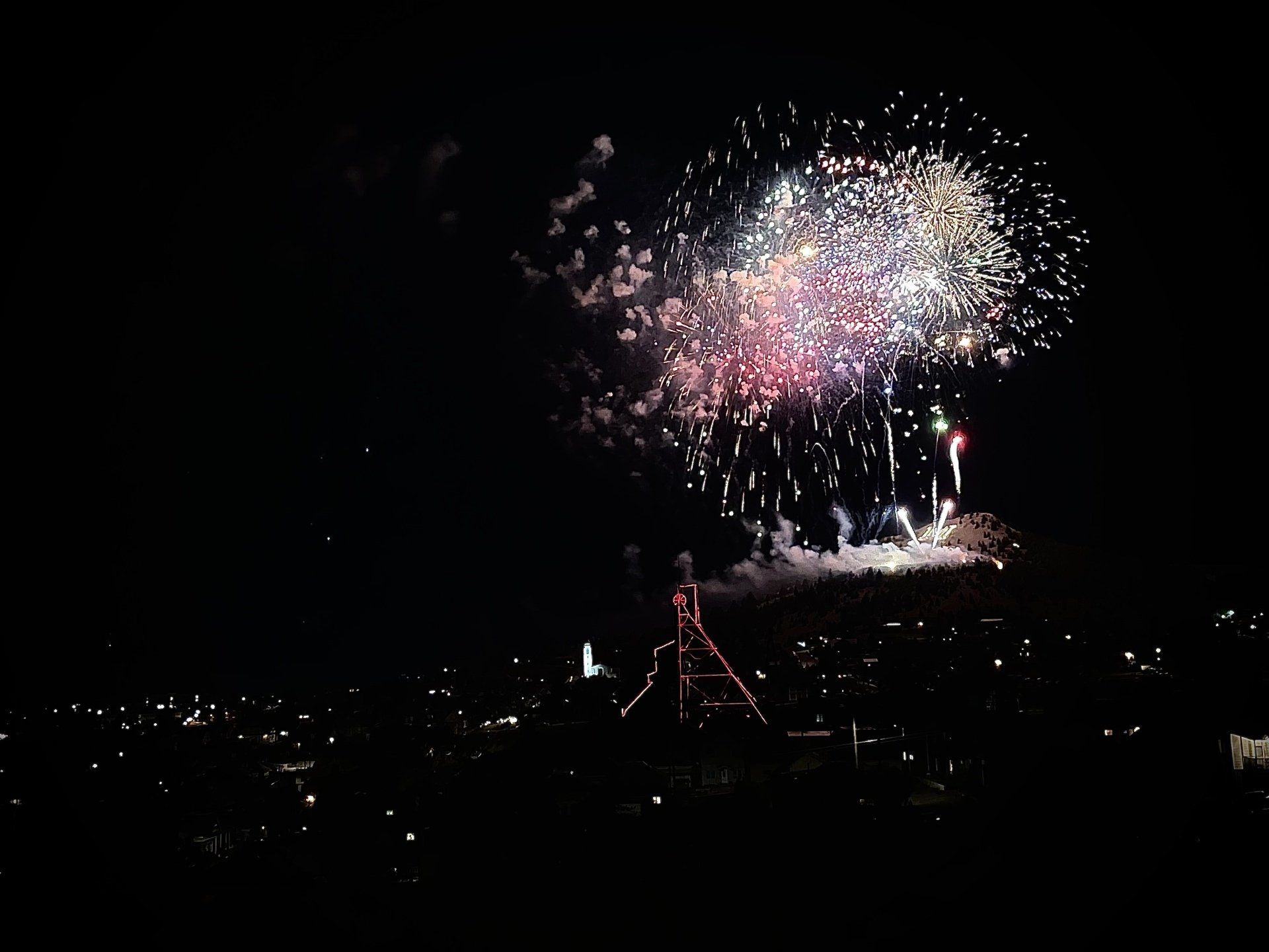 Fireworks exploding in the night sky over  Butte, MT