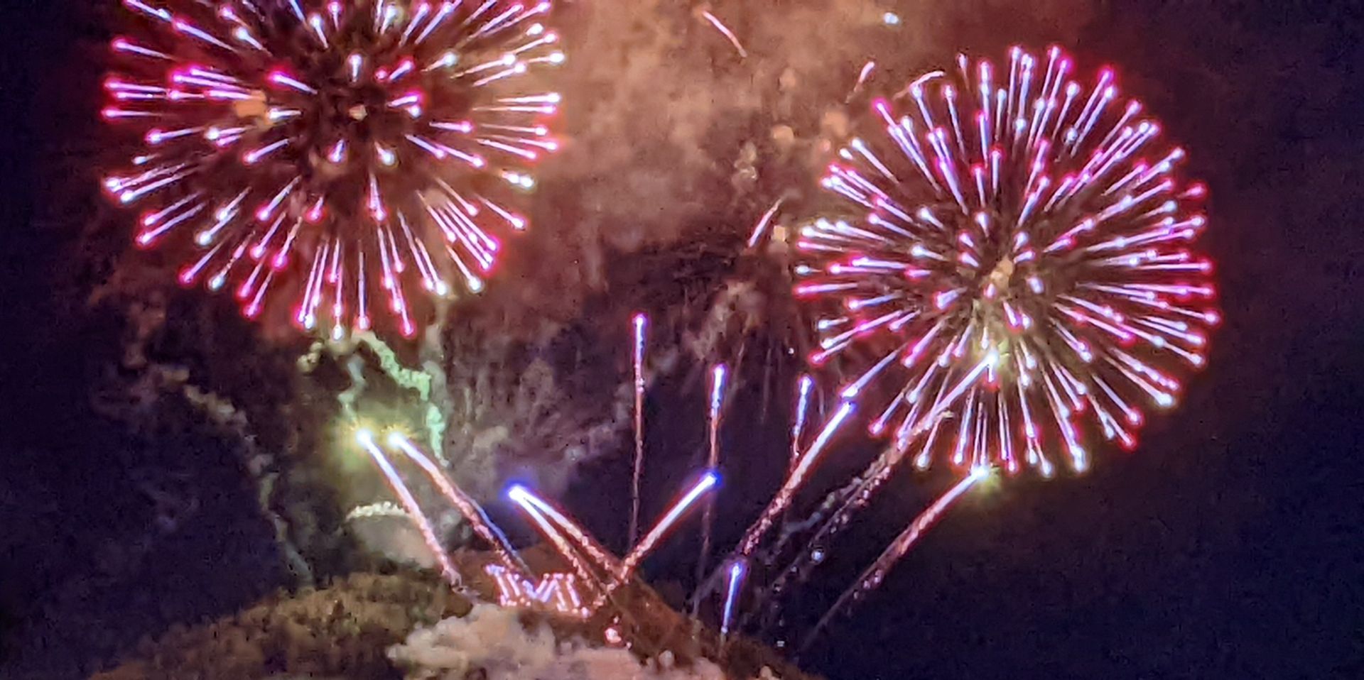 Fireworks exploding in the night sky over  Butte, MT