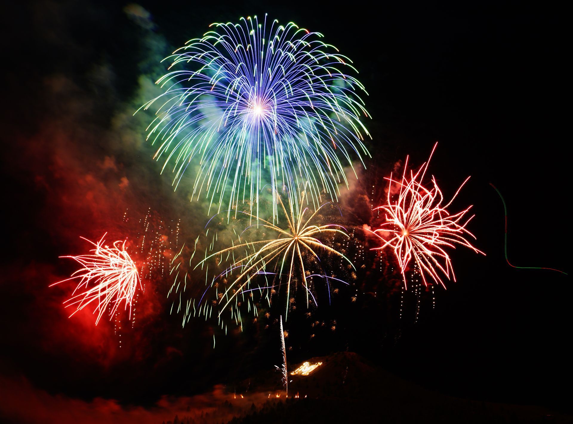 Fireworks exploding in the night sky over  Butte, MT