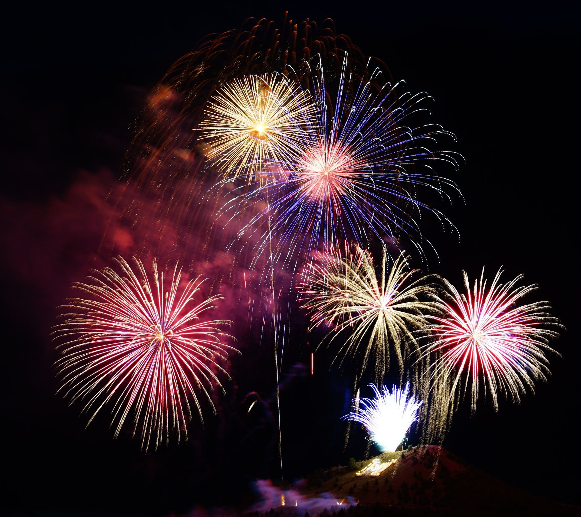 Fireworks exploding in the night sky over  Butte, MT