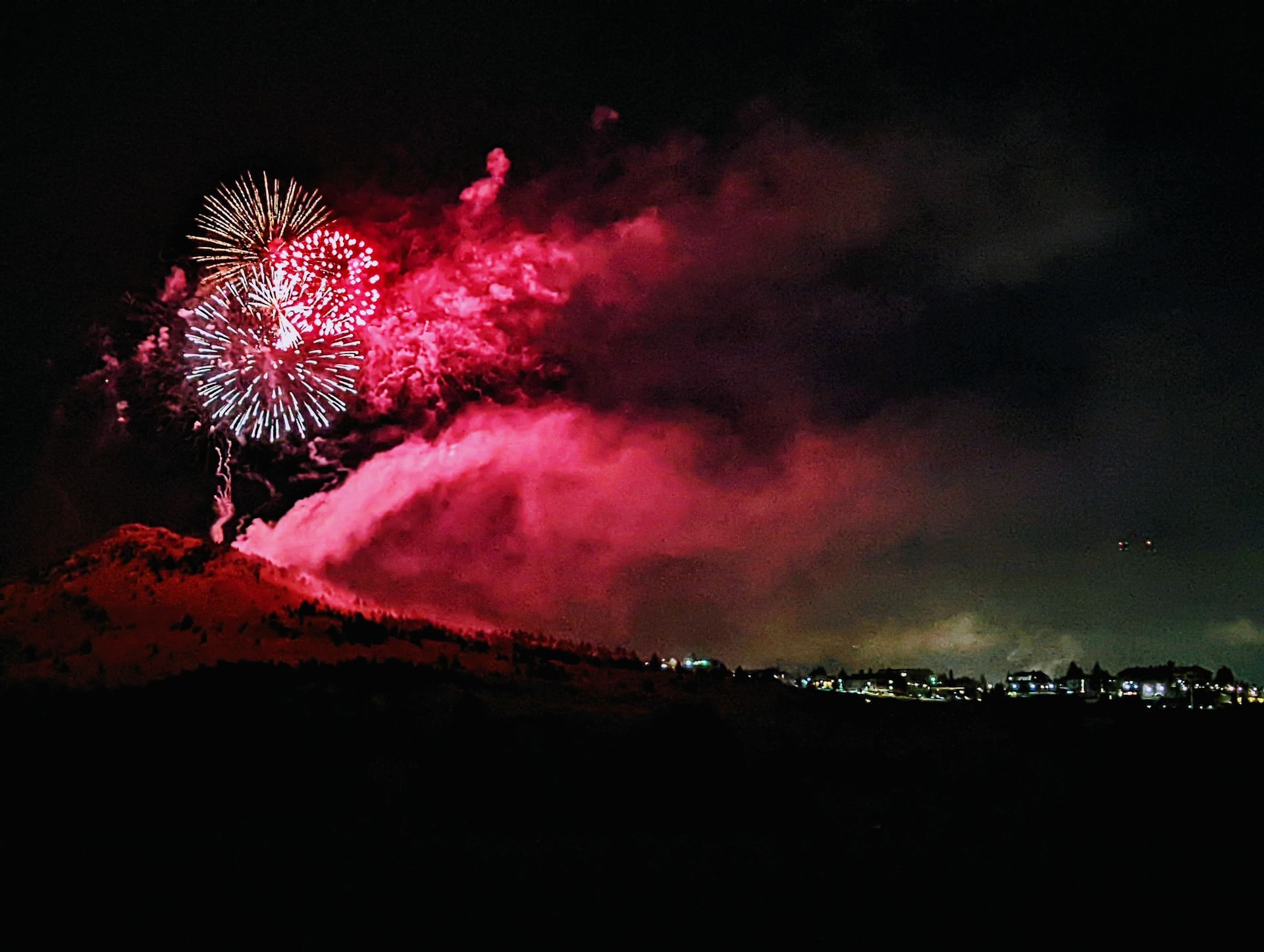 Fireworks exploding in the night sky over  Butte, MT