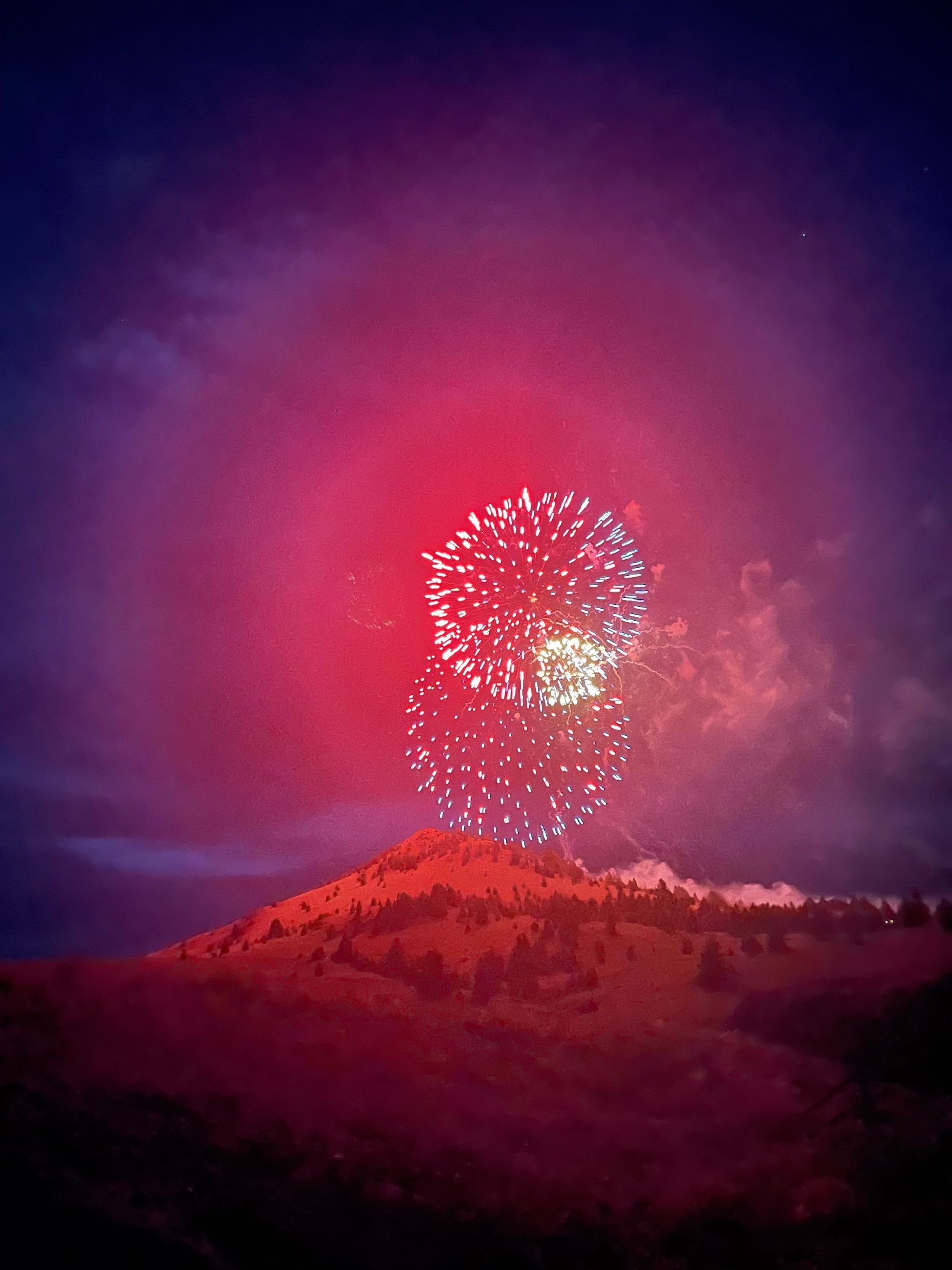 Fireworks exploding in the night sky over  Butte, MT