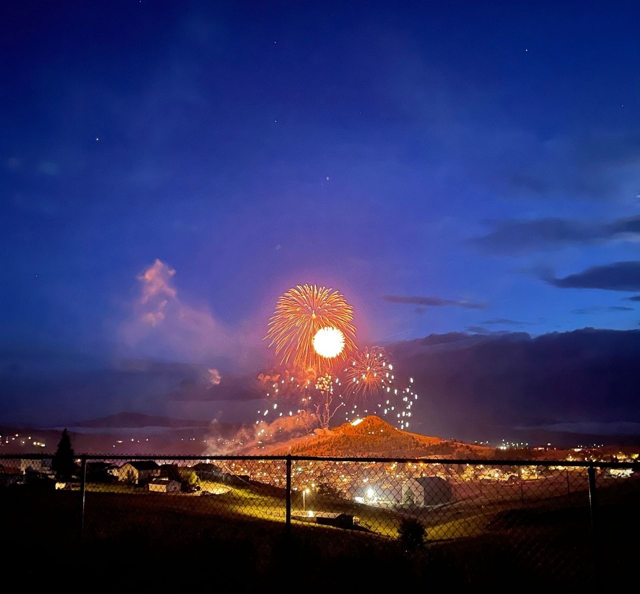 Fireworks exploding in the night sky over  Butte, MT