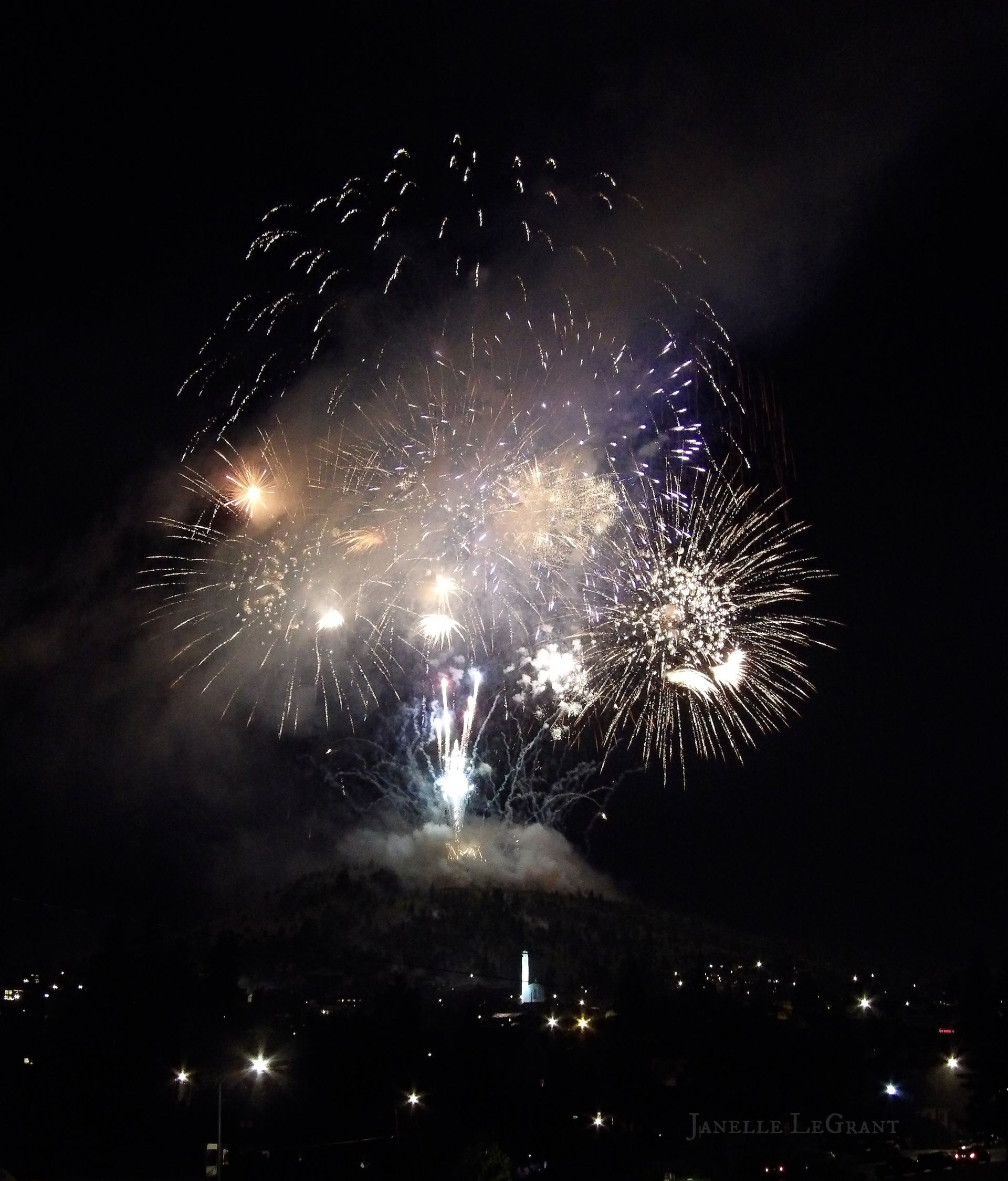 Fireworks exploding in the night sky over  Butte, MT