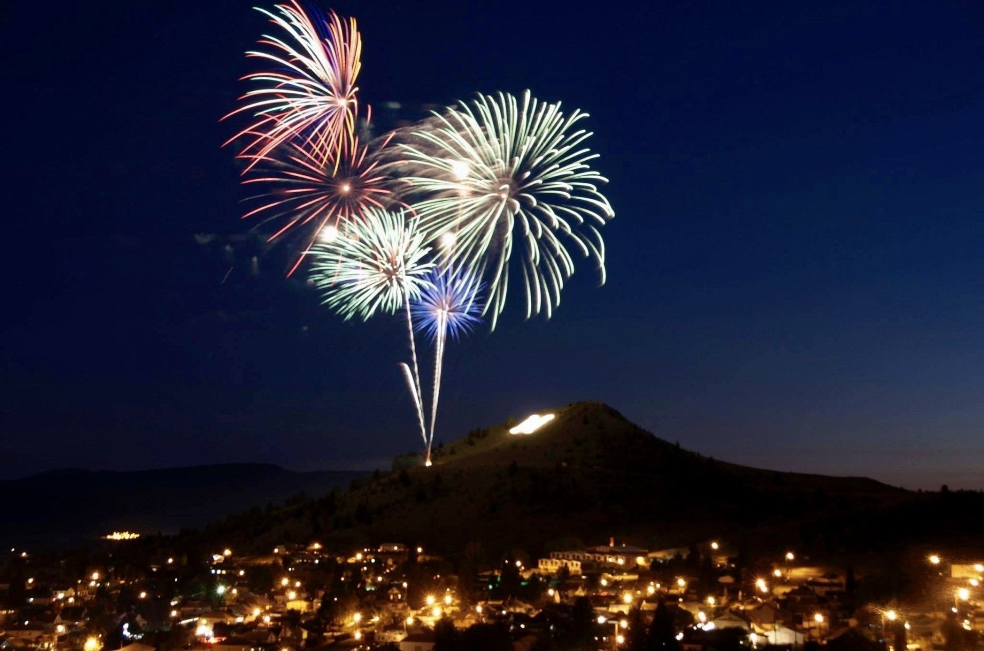 Fireworks exploding in the night sky over  Butte, MT
