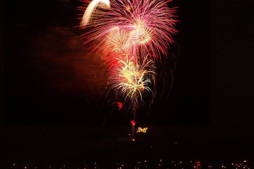 Tanya Ellie Fireworks exploding in the night sky over  Butte, MT