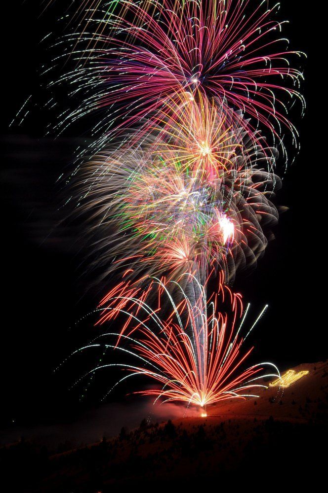 Kelsey Poore Fireworks exploding in the night sky over  Butte, MT