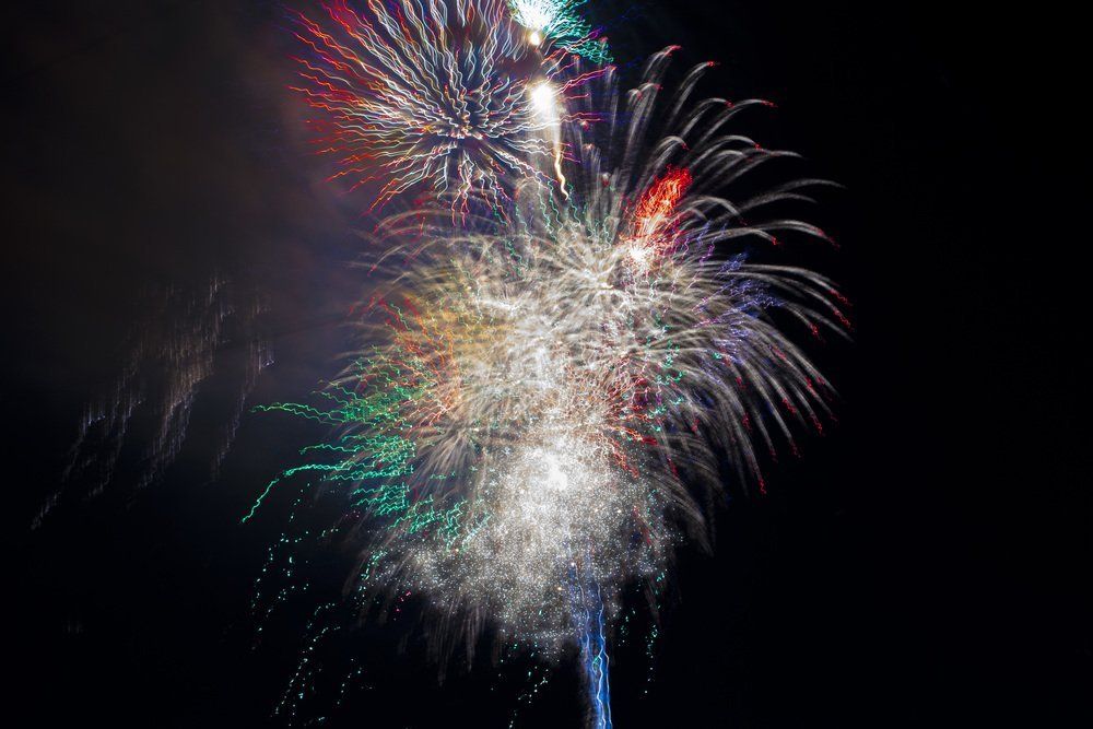 John Jolley Fireworks exploding in the night sky over  Butte, MT