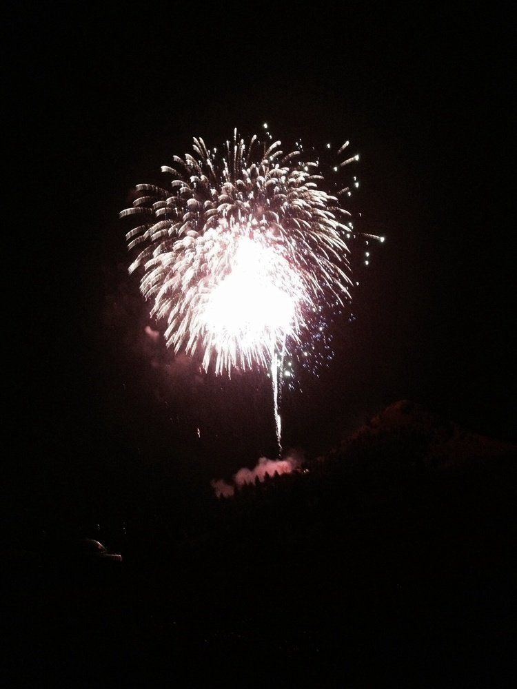 Kaytelin Hudson Fireworks exploding in the night sky over  Butte, MT