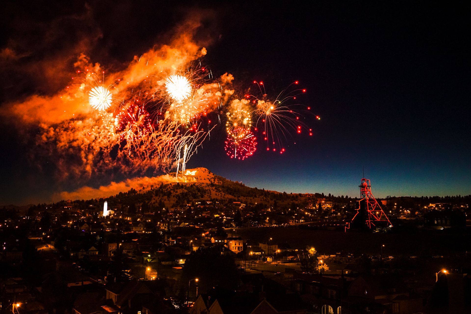 Fireworks exploding in the night sky over  Butte, MT