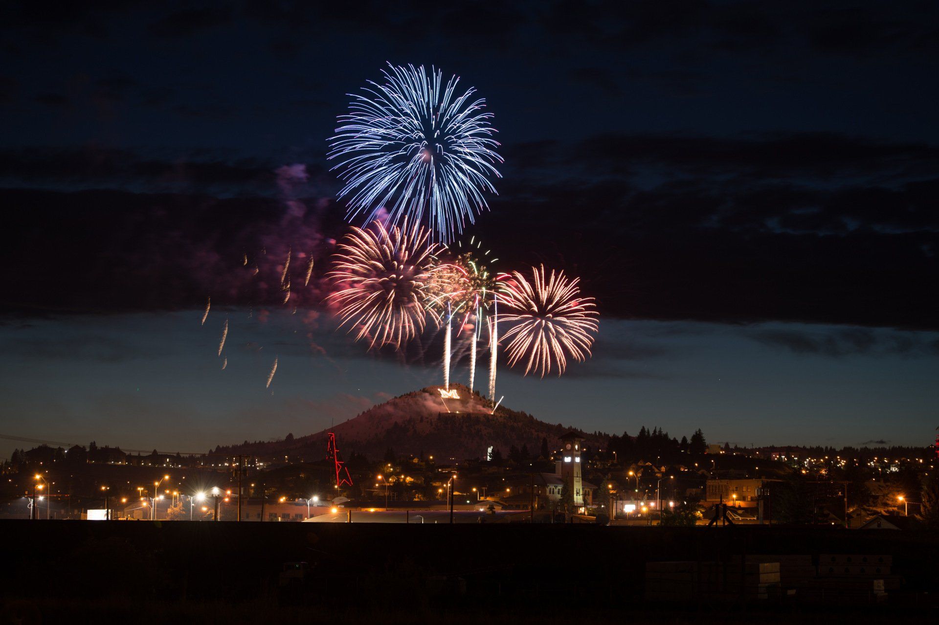 Fireworks exploding in the night sky over  Butte, MT