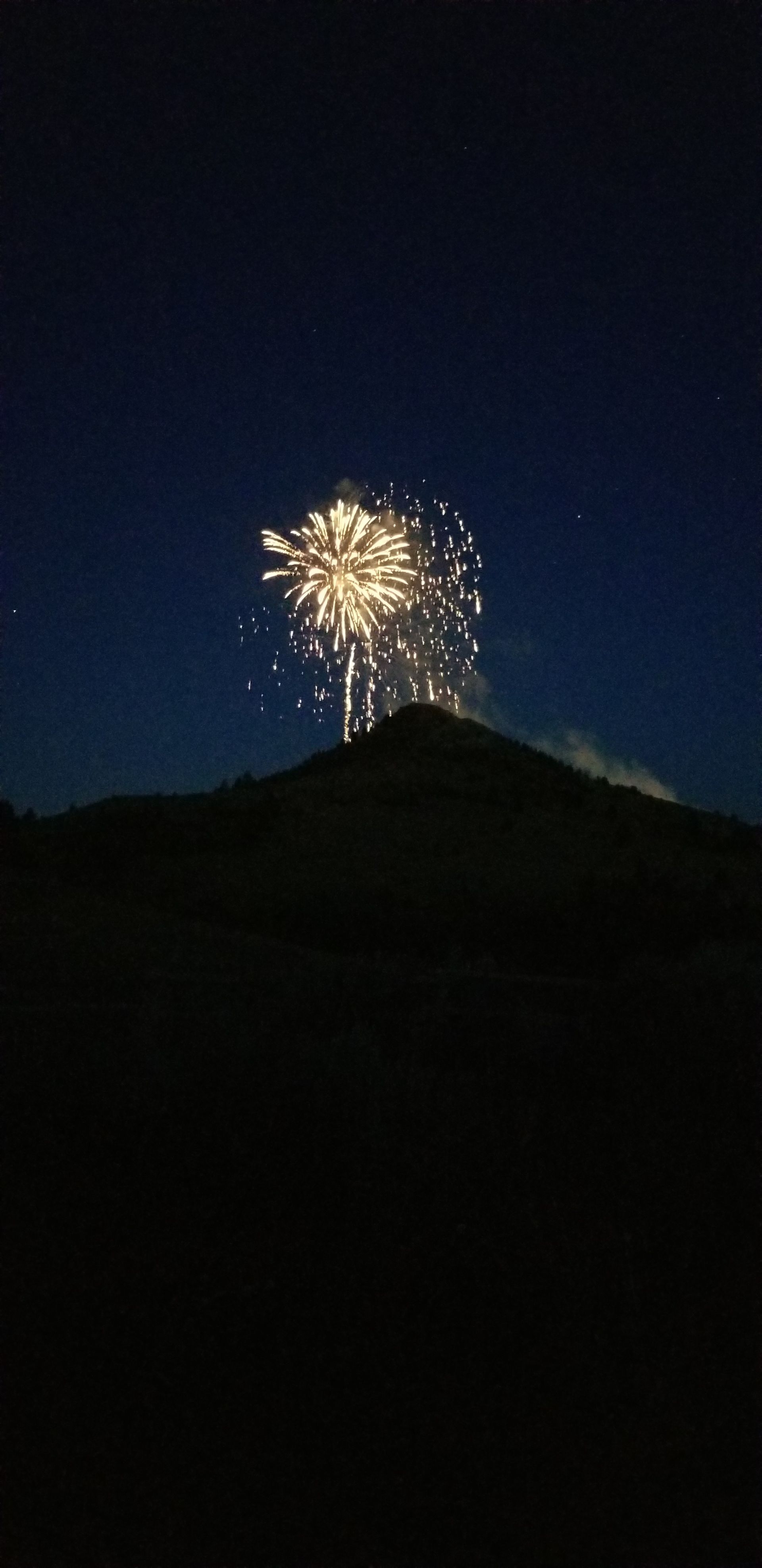 Fireworks exploding in the night sky over  Butte, MT