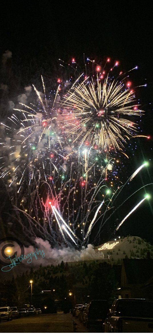 Fireworks exploding in the night sky over  Butte, MT