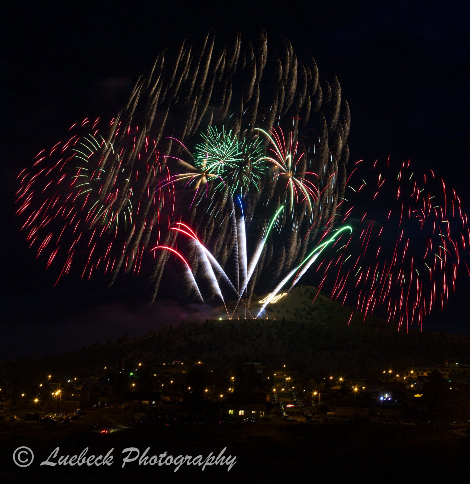 Fireworks exploding in the night sky over  Butte, MT