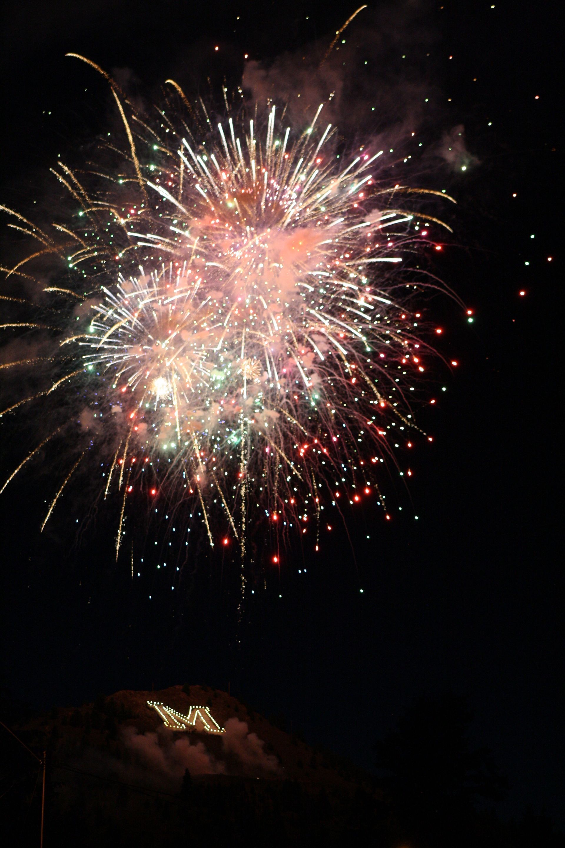 Fireworks exploding in the night sky over  Butte, MT