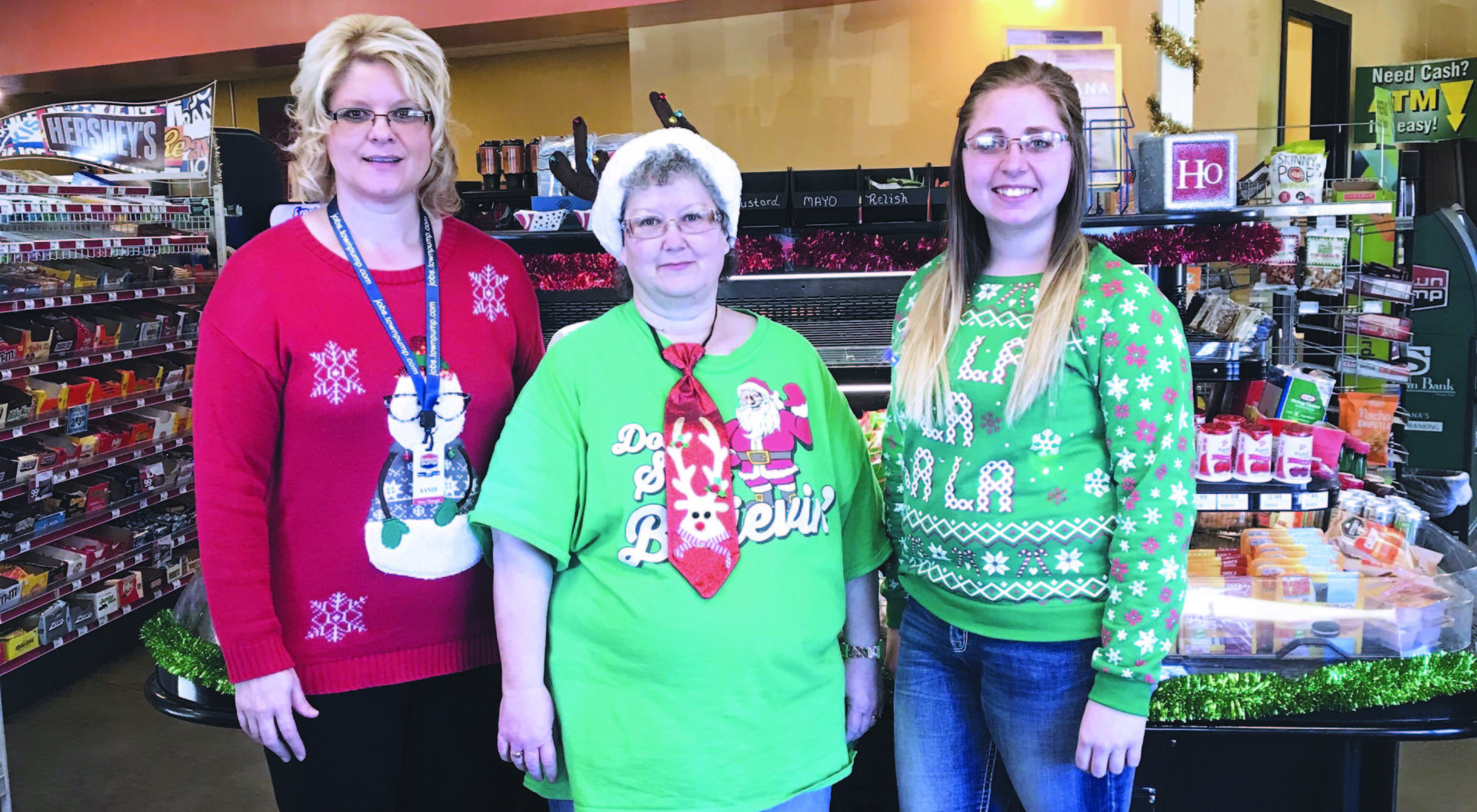 Laurel 1 C-Store employees pose in Christmas sweaters