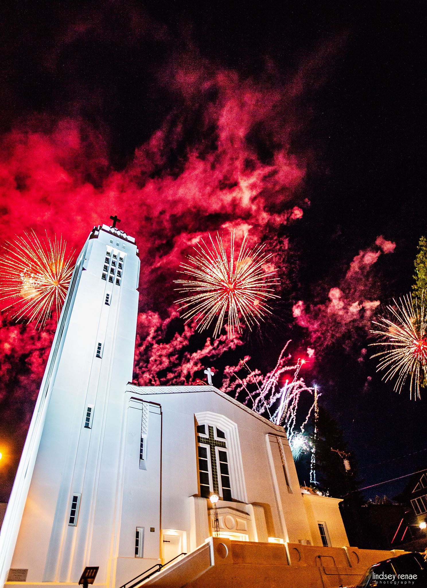 Fireworks exploding in the night sky over  Butte, MT with the Immaculate Conception church in the foreground