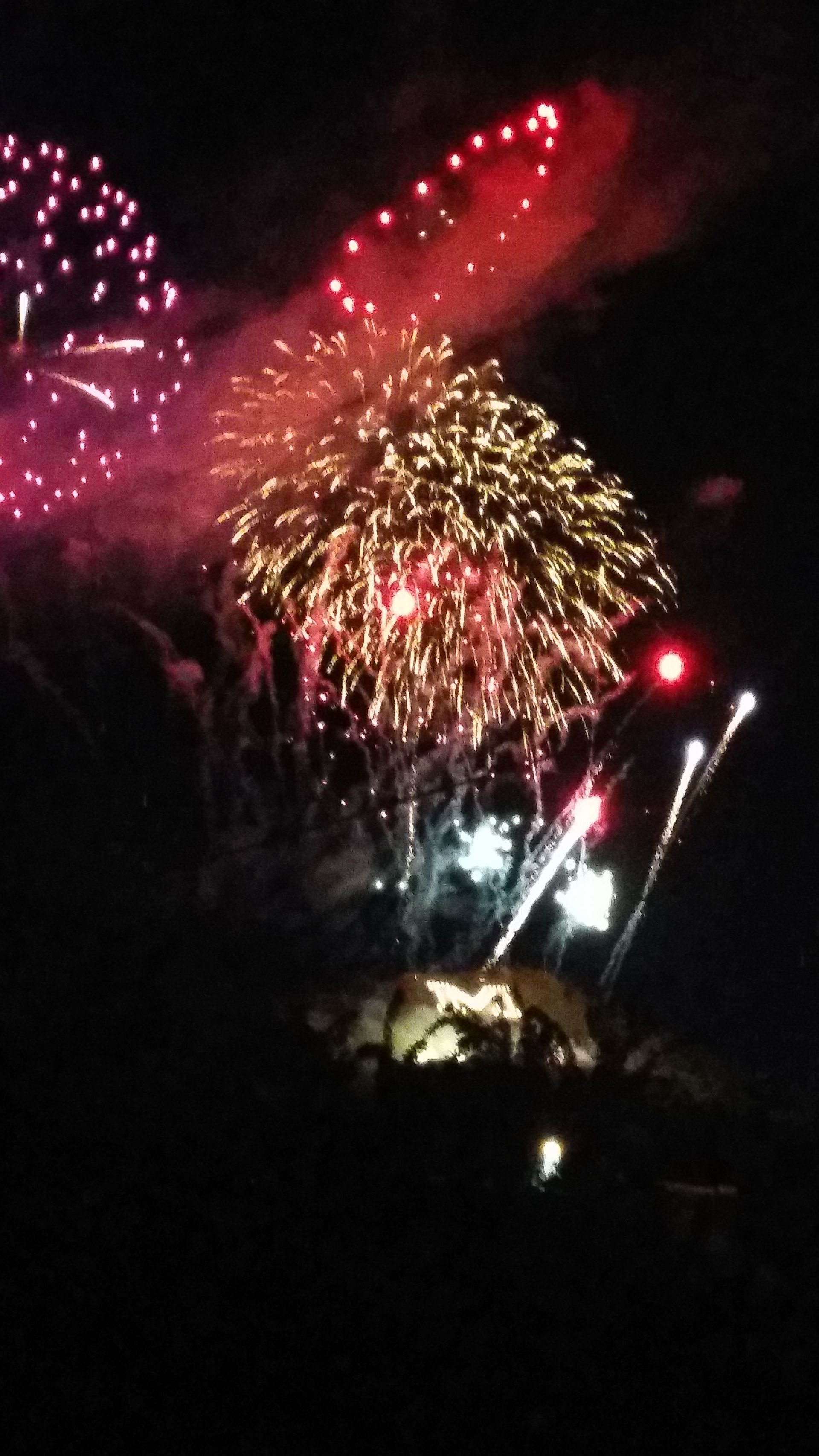 Fireworks exploding in the night sky over  Butte, MT