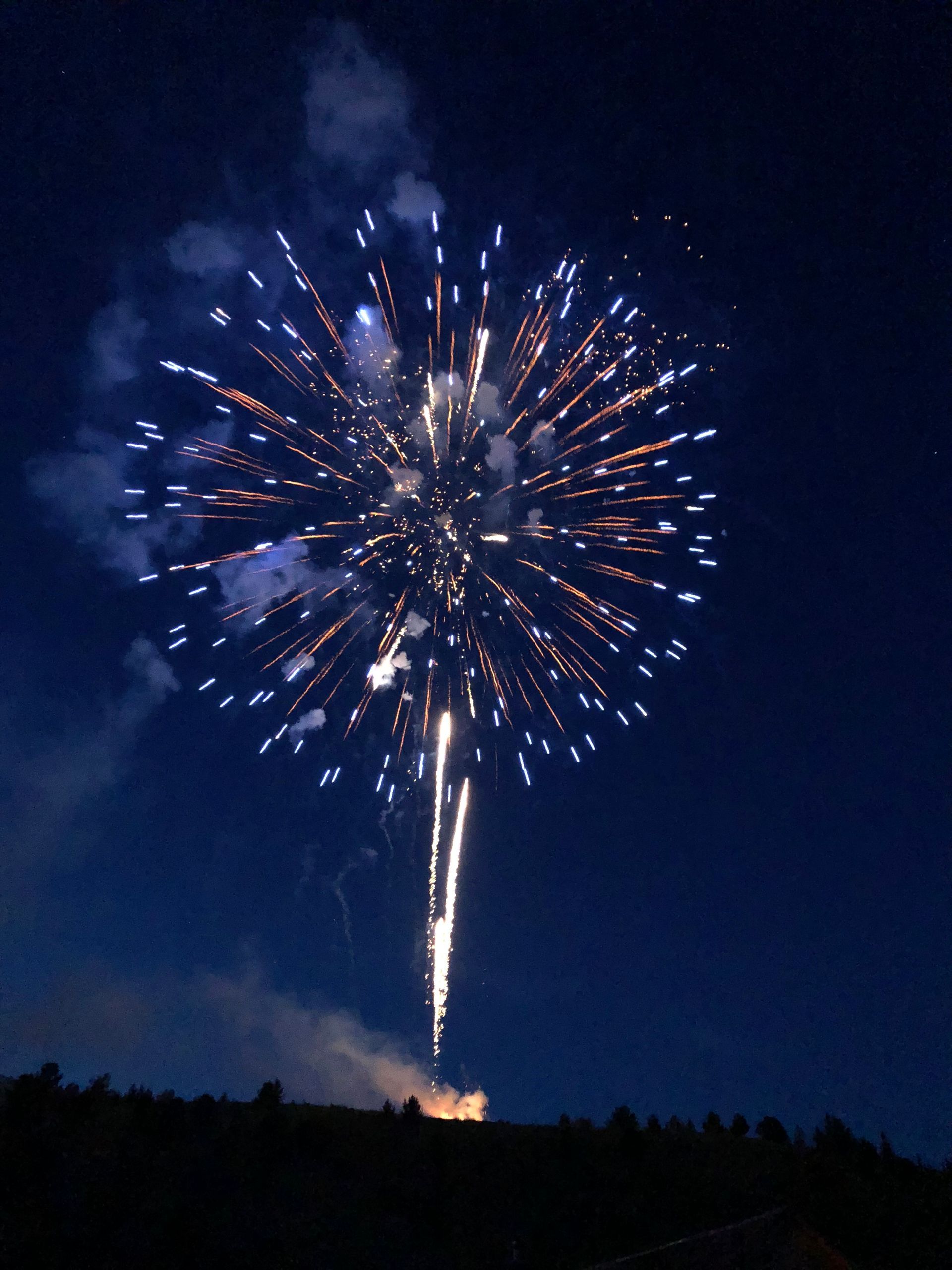Fireworks exploding in the night sky over  Butte, MT