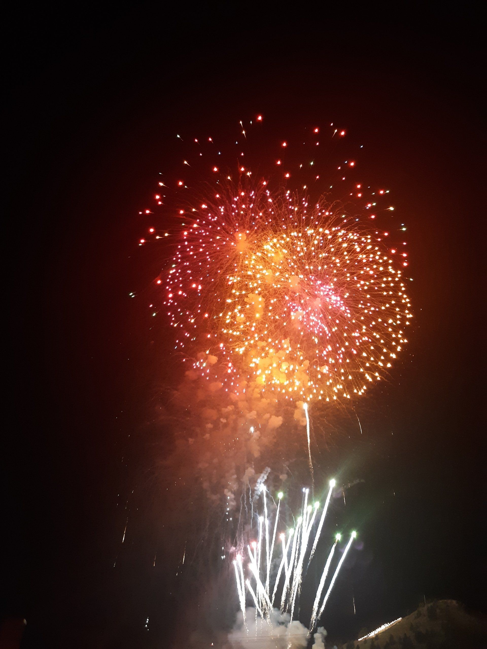 Fireworks exploding in the night sky over  Butte, MT