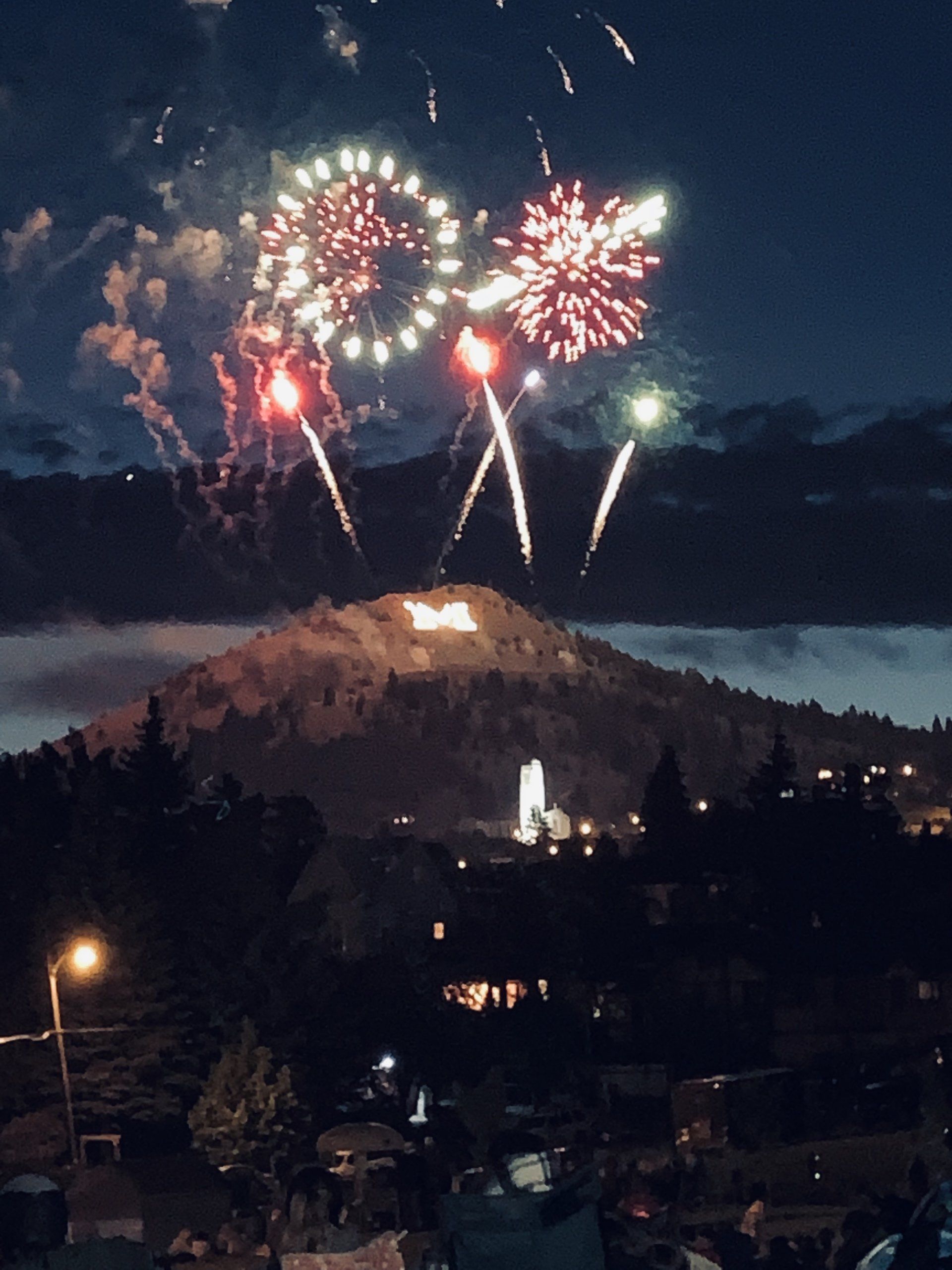 Fireworks exploding in the night sky over  Butte, MT