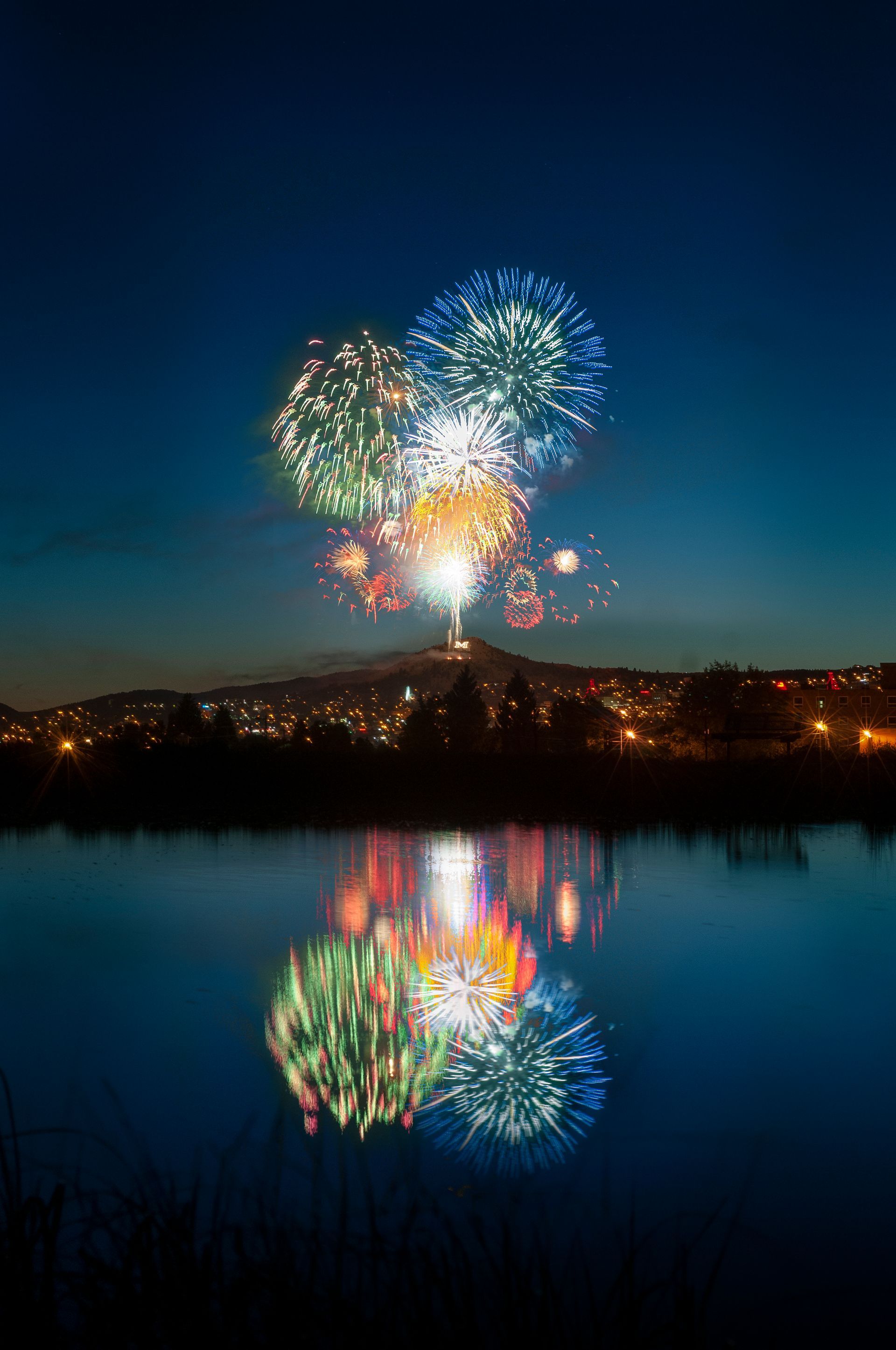 Fireworks exploding in the night sky over  Butte, MT